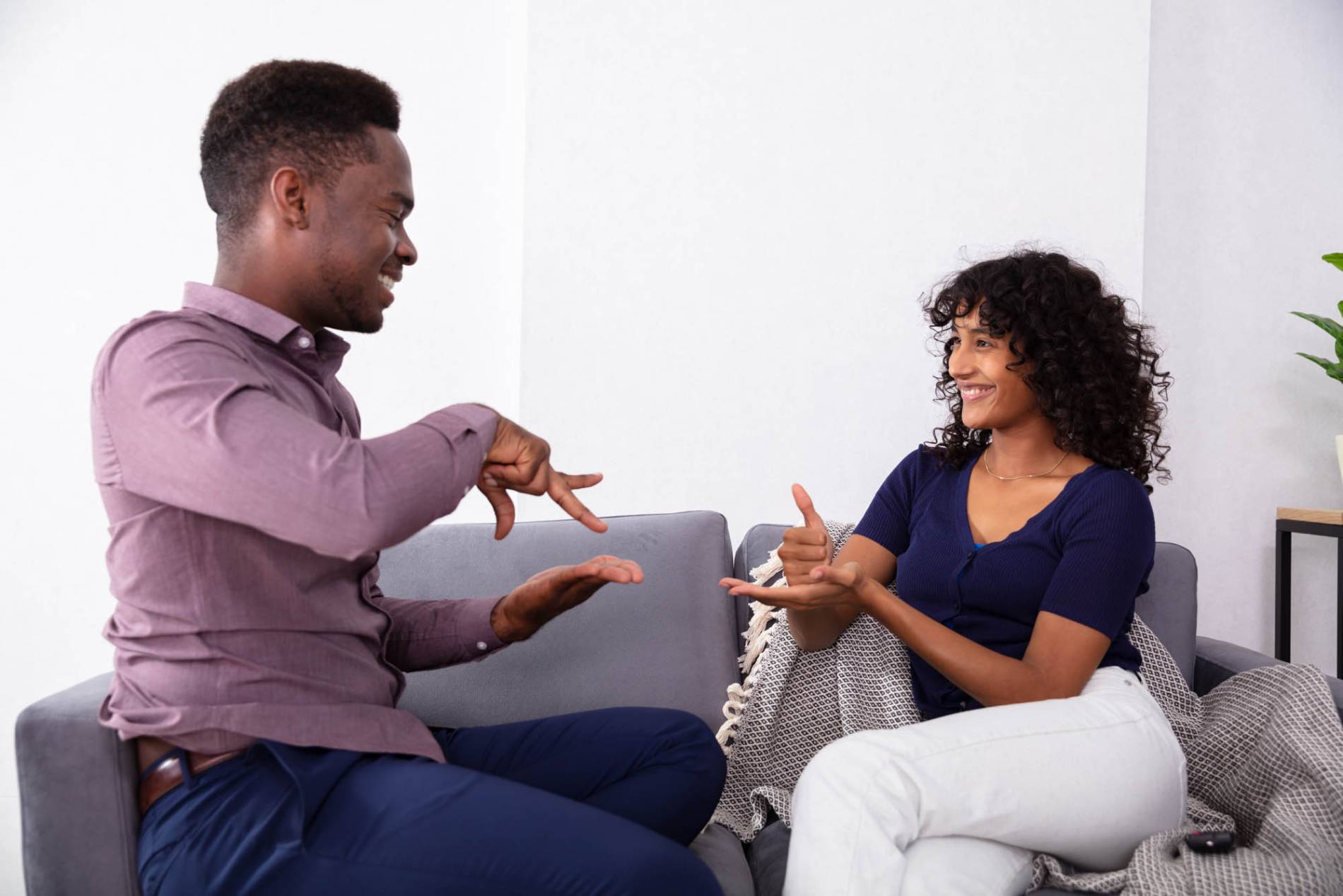 black male communicating with hispanic female in american sign language