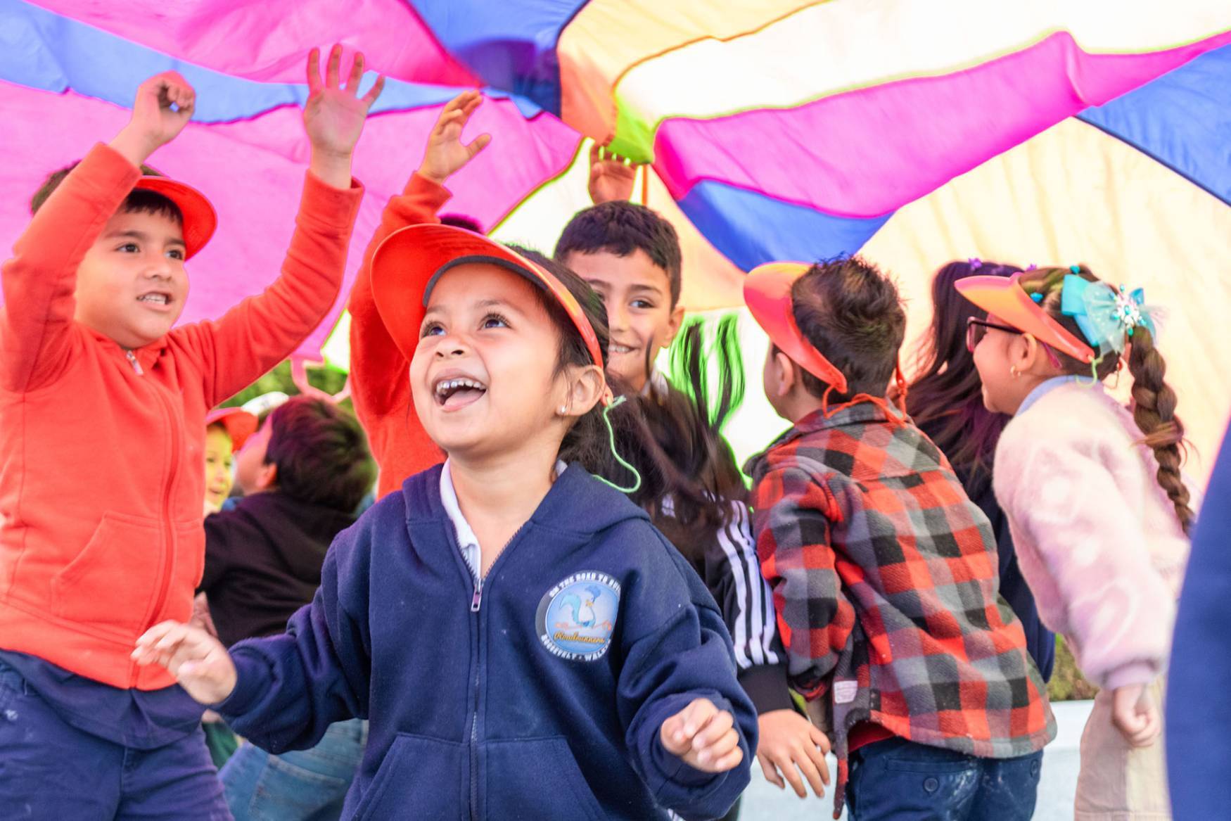 Children running under parachute
