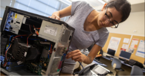 Female student assembling a hard drive