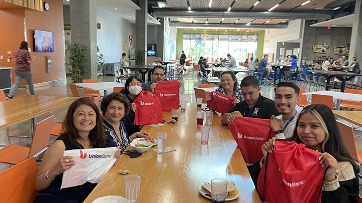 Gallegos seated 2nd on the left side at a celebration lunch with Dean of Counseling Maria Dela Cruz, Ph.D., and students