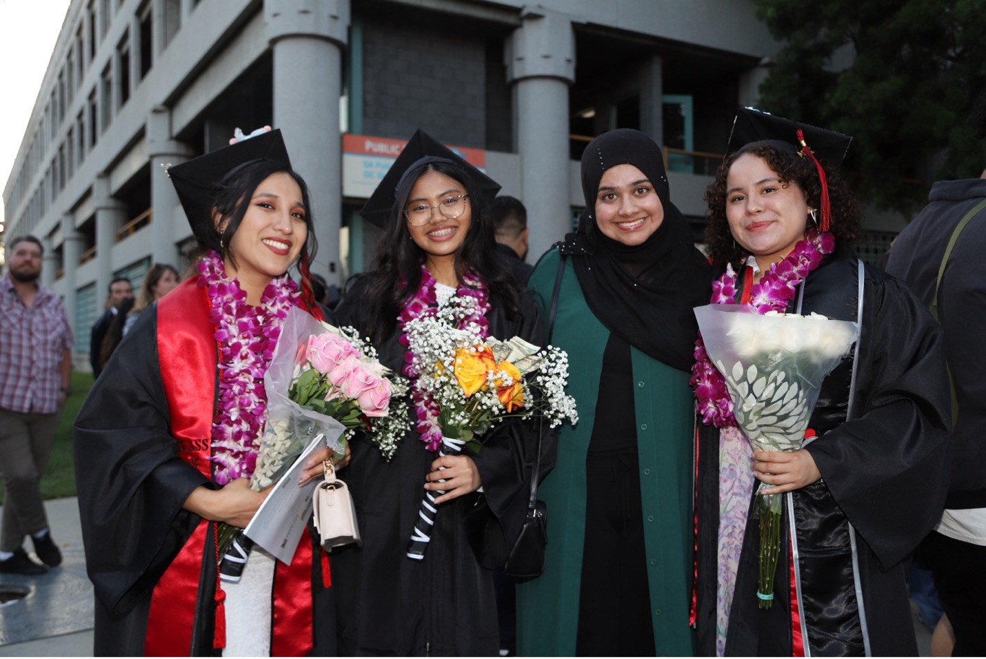 Four female SAC students in cap and gown