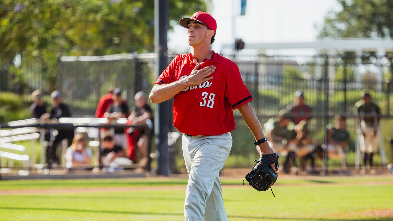 Andrew Phillips celebrates by beating his chest while walking off the mound