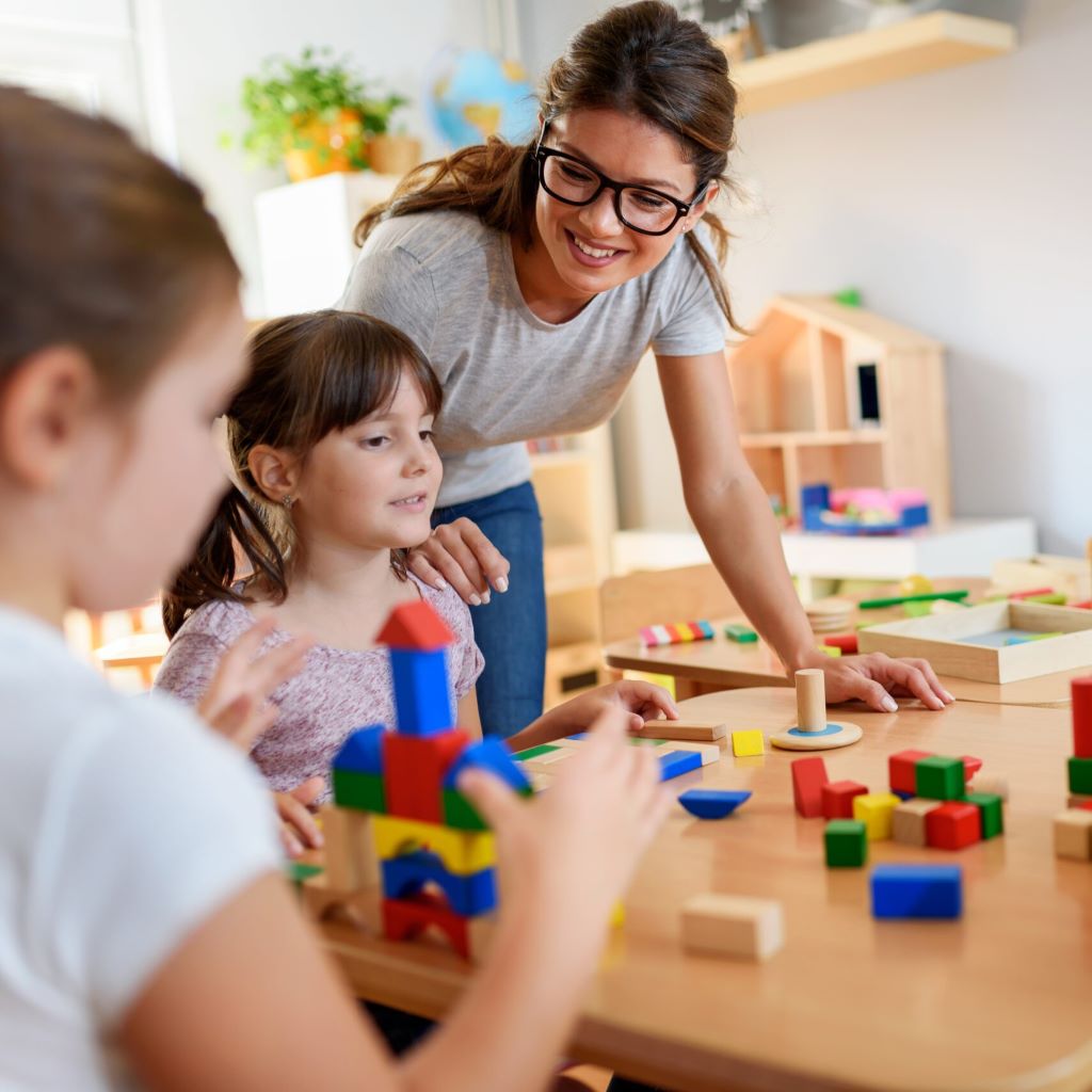 Woman taking care of children after starting her own childcare business using skills learned at Continuing Education
