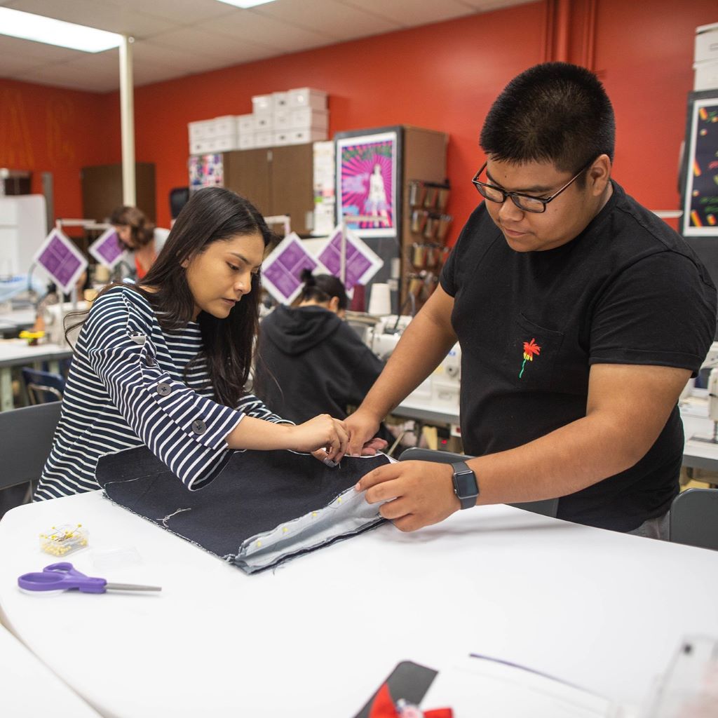 Students designing fashionable clothing after learning skills from free classes at Santa Ana College