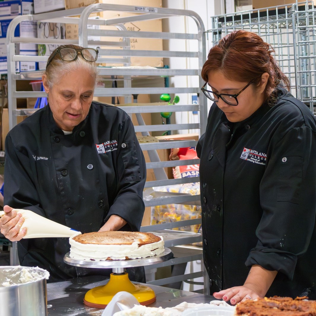 Women working as line cooks in kitchen restaurant after finishing certificate at Santa Ana College