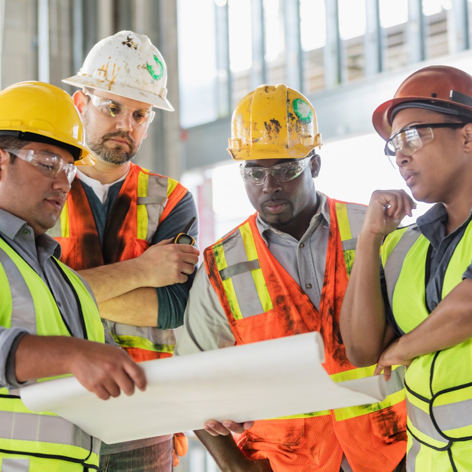 Group of male construction workers using skills you can learn for free at Santa Ana College 
