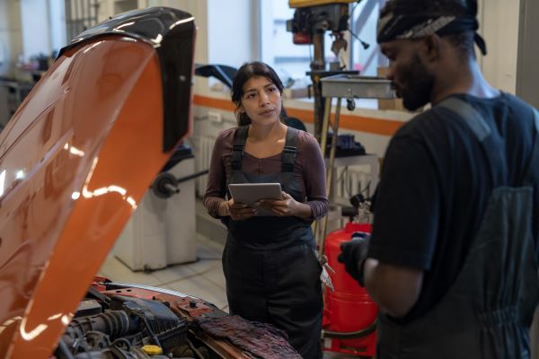 Diverse car mechanics running successful mechanic business after completing automotive technology certificate