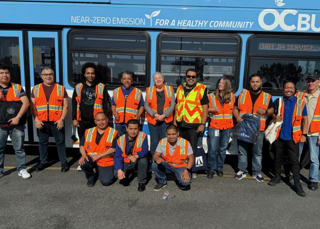 Students standing in front of bus after completing the free Continuing Education Bus Operator/Driver class
