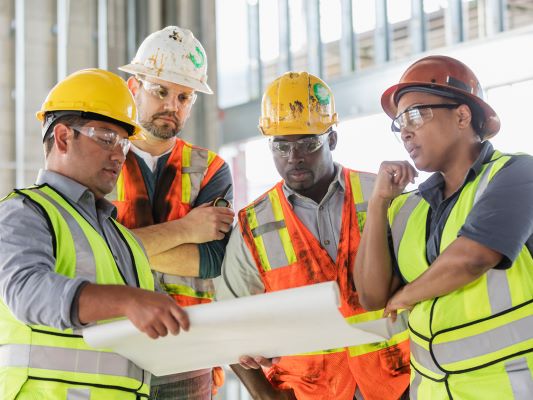 Group of male construction workers using skills you can learn for free at Santa Ana College 