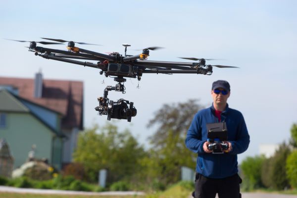 Man piloting a drone for his new business after taking career education class at Santa Ana College