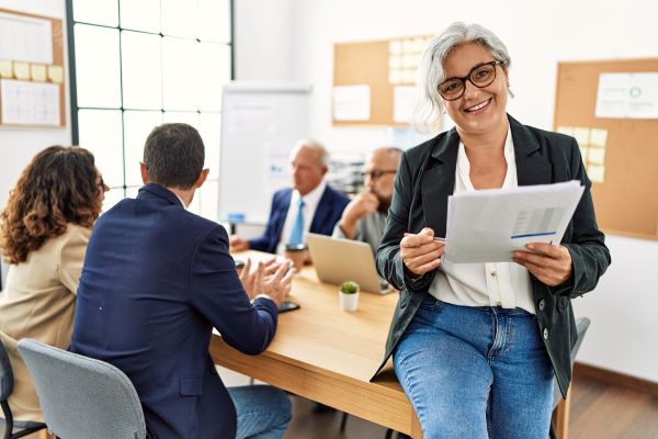 Woman smiling in business meeting after becoming a certified global business professional at Santa Ana College