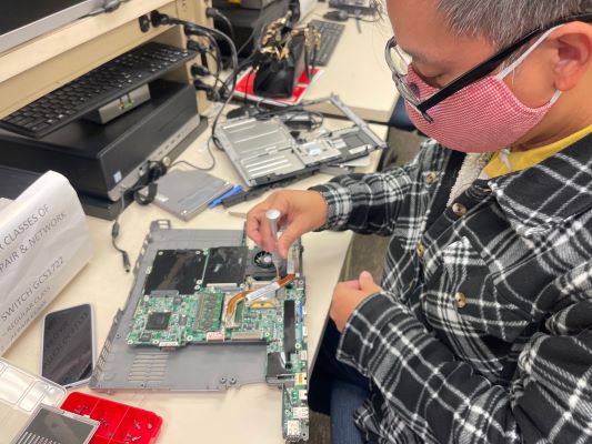 Computer Repair student practicing in free class at Santa Ana College, near Anaheim, Irvine, and Westminster