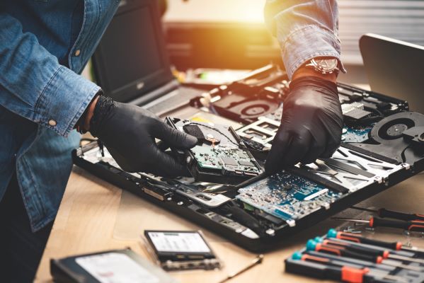 IT repairing broken computer. with skills from continuing education classes near Garden Grove, Orange, and Tustin
