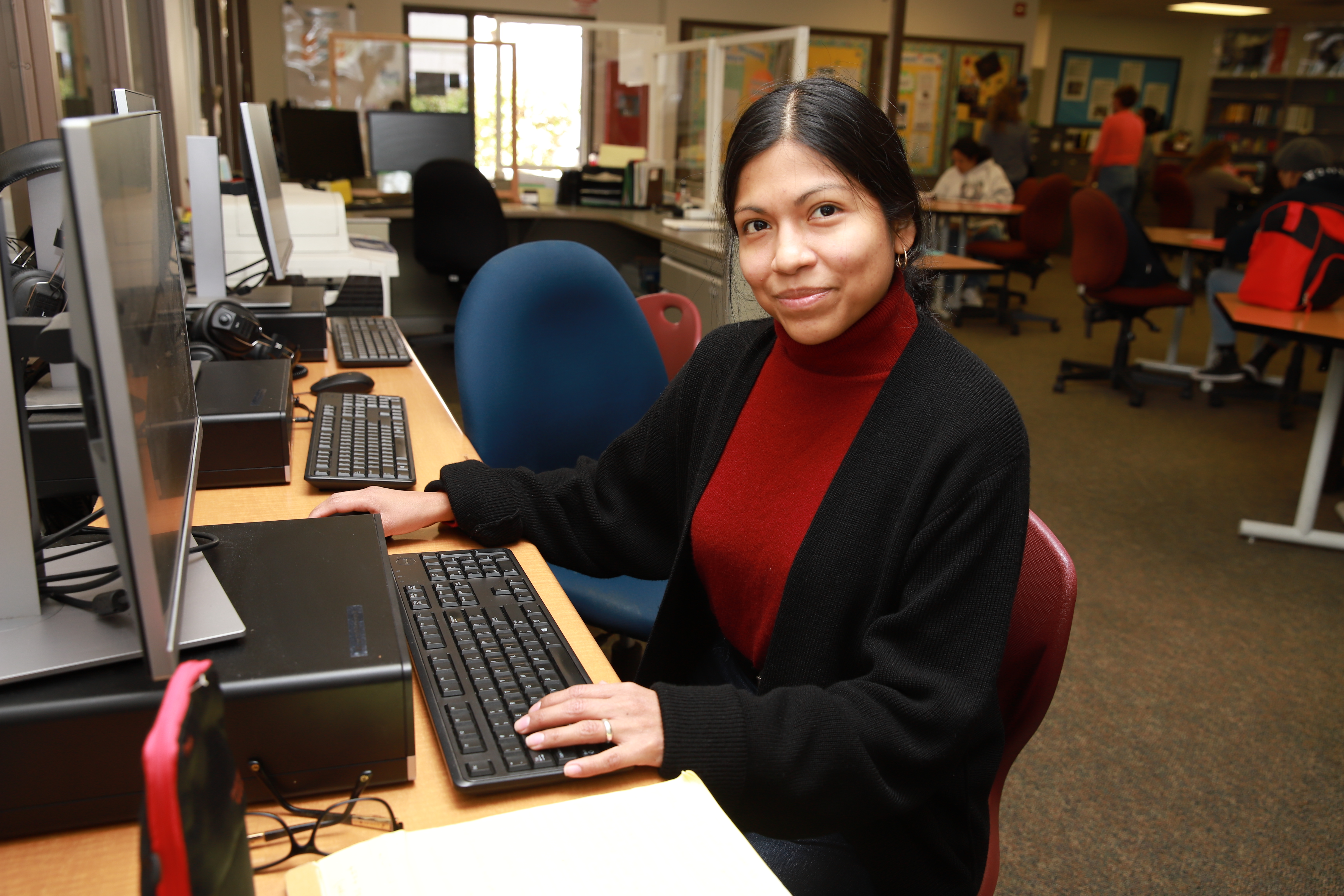 Woman working towards employment goals at computer in Career Center 