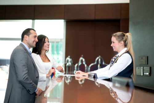 Hotel desk hosted by woman after finishing certificate program at Santa Ana College, near Irvine, Anaheim, and Tustin